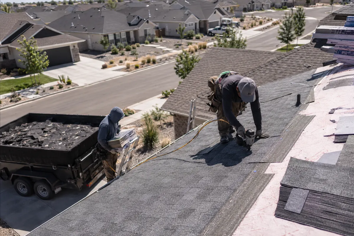 Roofing crew installing architectural asphalt shingles on a residential home in Boise, Idaho
